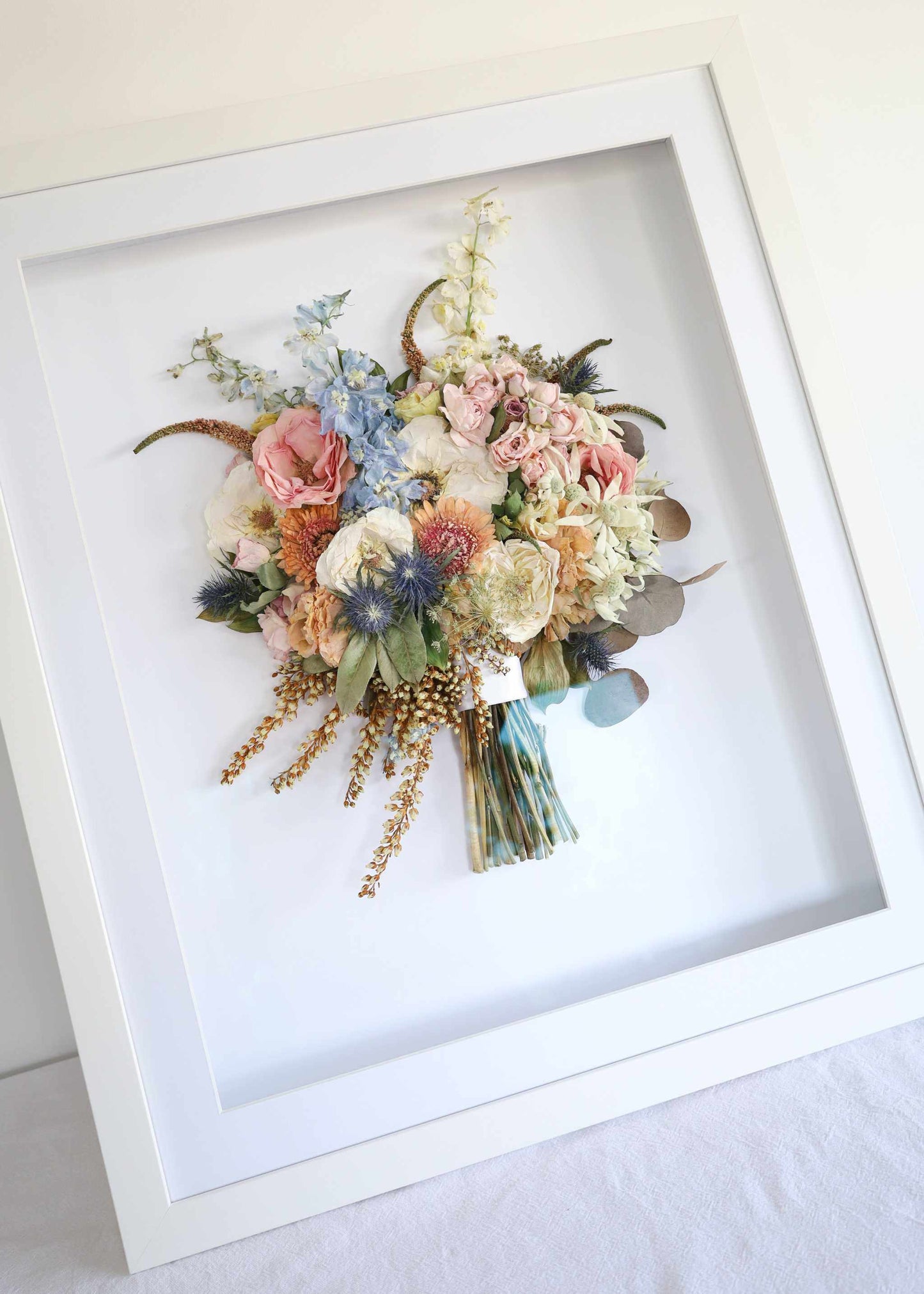 Framed preserved bouquet in a 50x60 custom handcrafted frame with UV protective glass