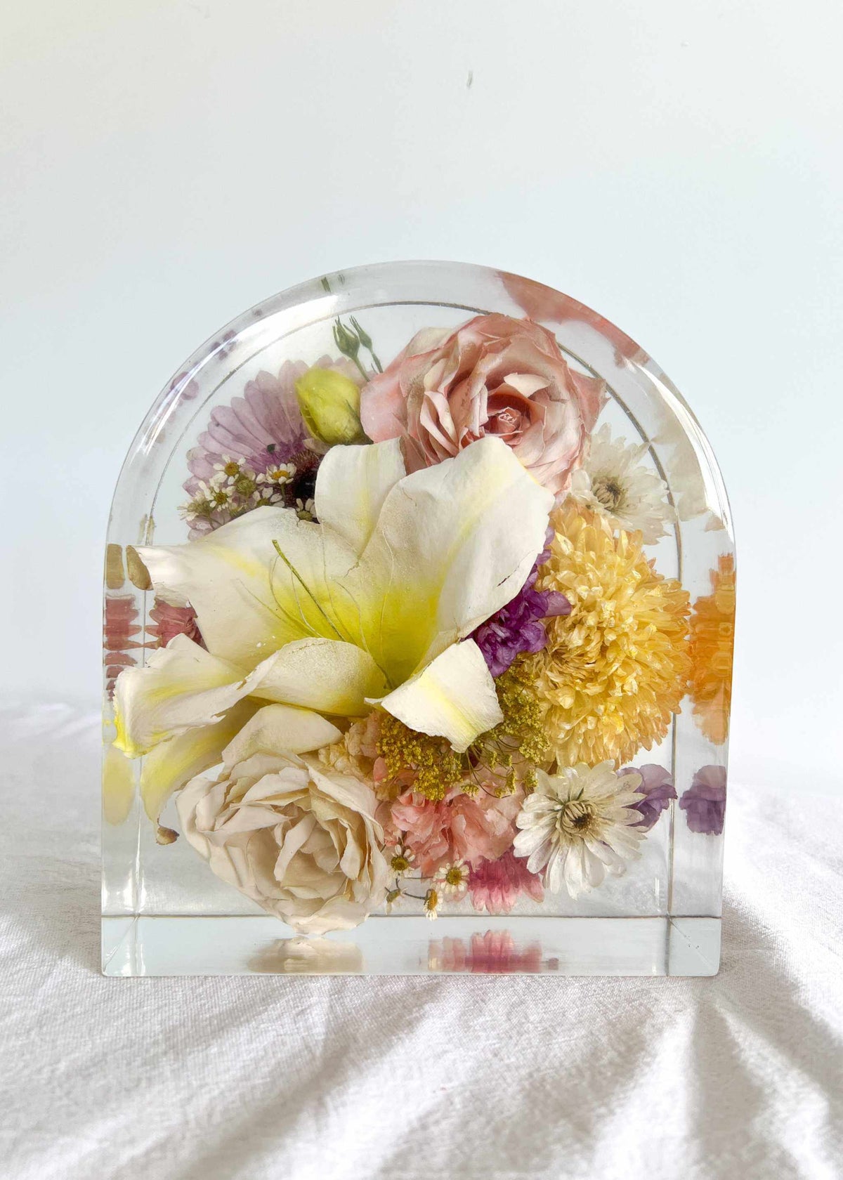 Flowers preserved in clear resin arch display block