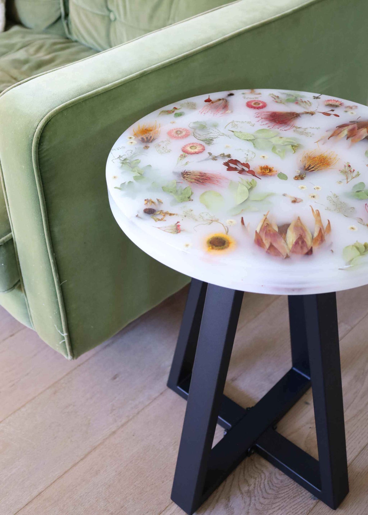 Custom floral resin side table with preserved dried flowers and black legs on a 45cm diameter top