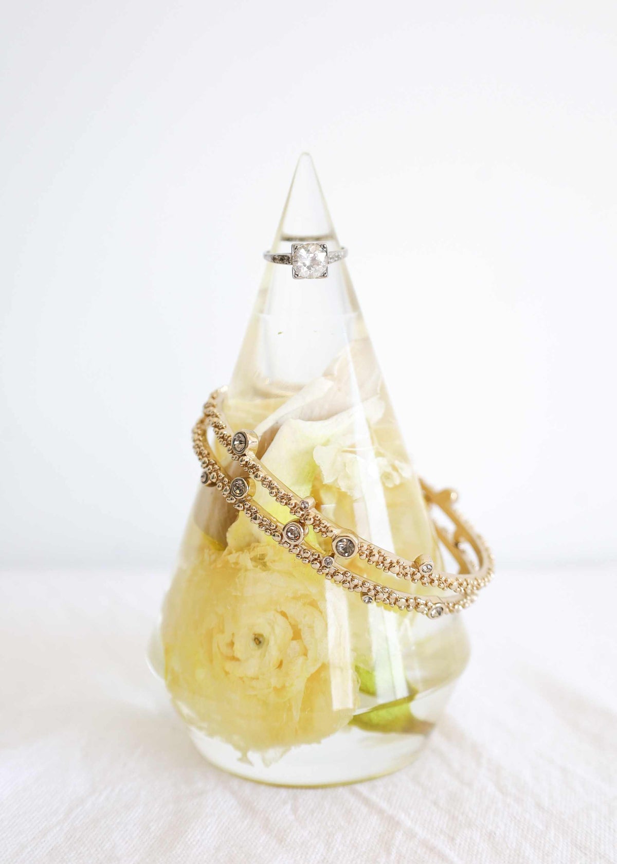 Everyday Resin Keepsake Bundle featuring a clear resin ring holder with a preserved yellow flower and gold-toned rings