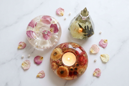 Everyday Resin Keepsake Bundle with three clear resin pieces, preserved pink and orange flowers, a dish, ring holder and candle holder.