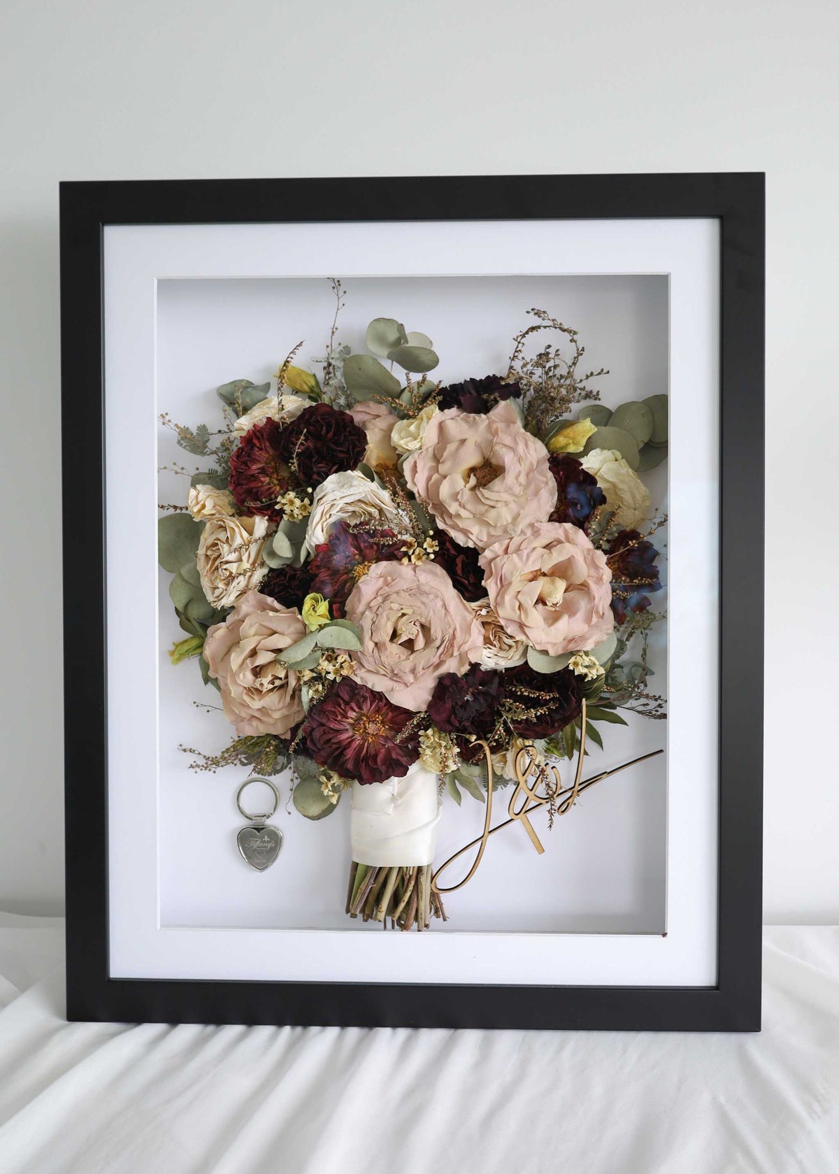 Flower frame duo showing a preserved bouquet of blush roses and burgundy blooms in a black shadow box frame.