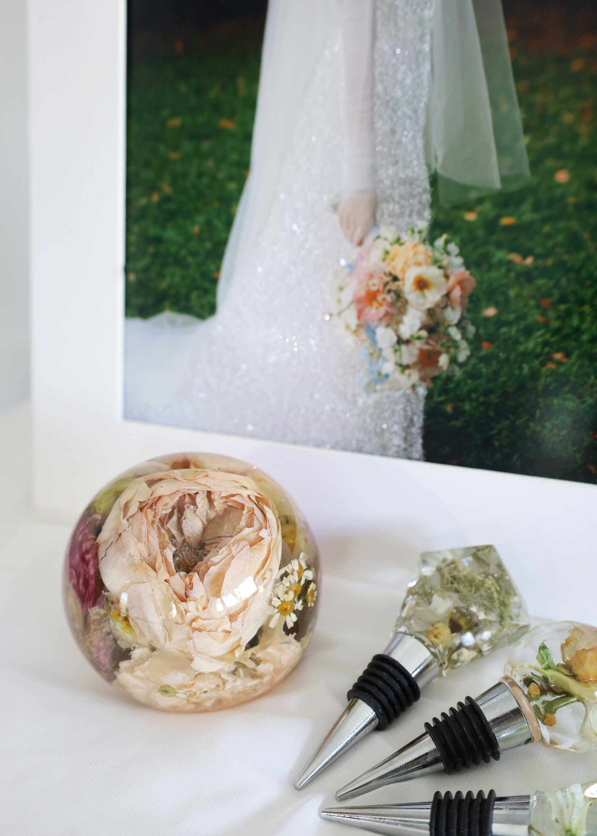 Mini Memories Preservation Package featuring preserved bridal bouquet in resin dome, resin bottle stoppers, and custom diamond glitter print framed display