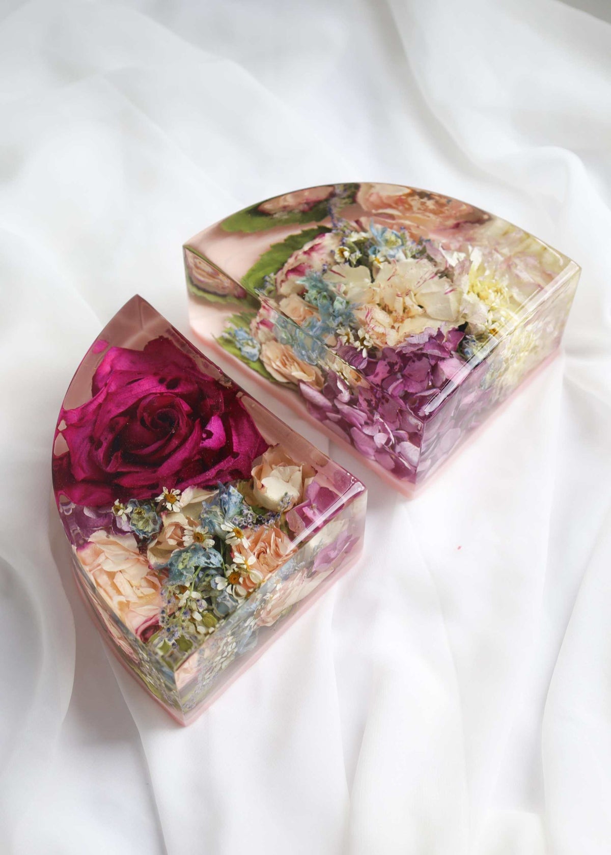 Set of resin display book ends with dried flowers encased, available in clear or black background options