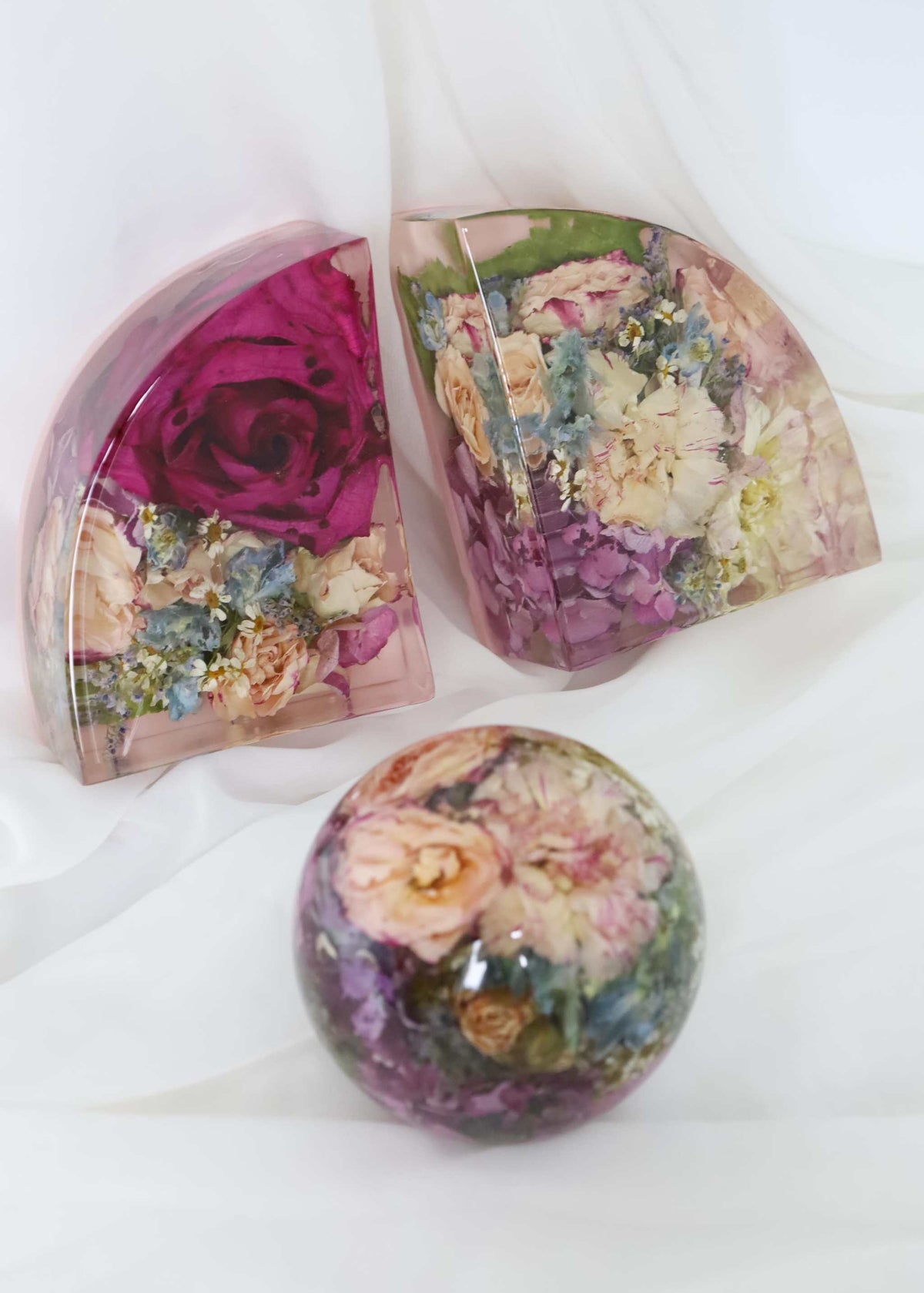Bridal Preservation All Resin Package featuring clear resin floral keepsakes with preserved pink, cream and purple flowers.