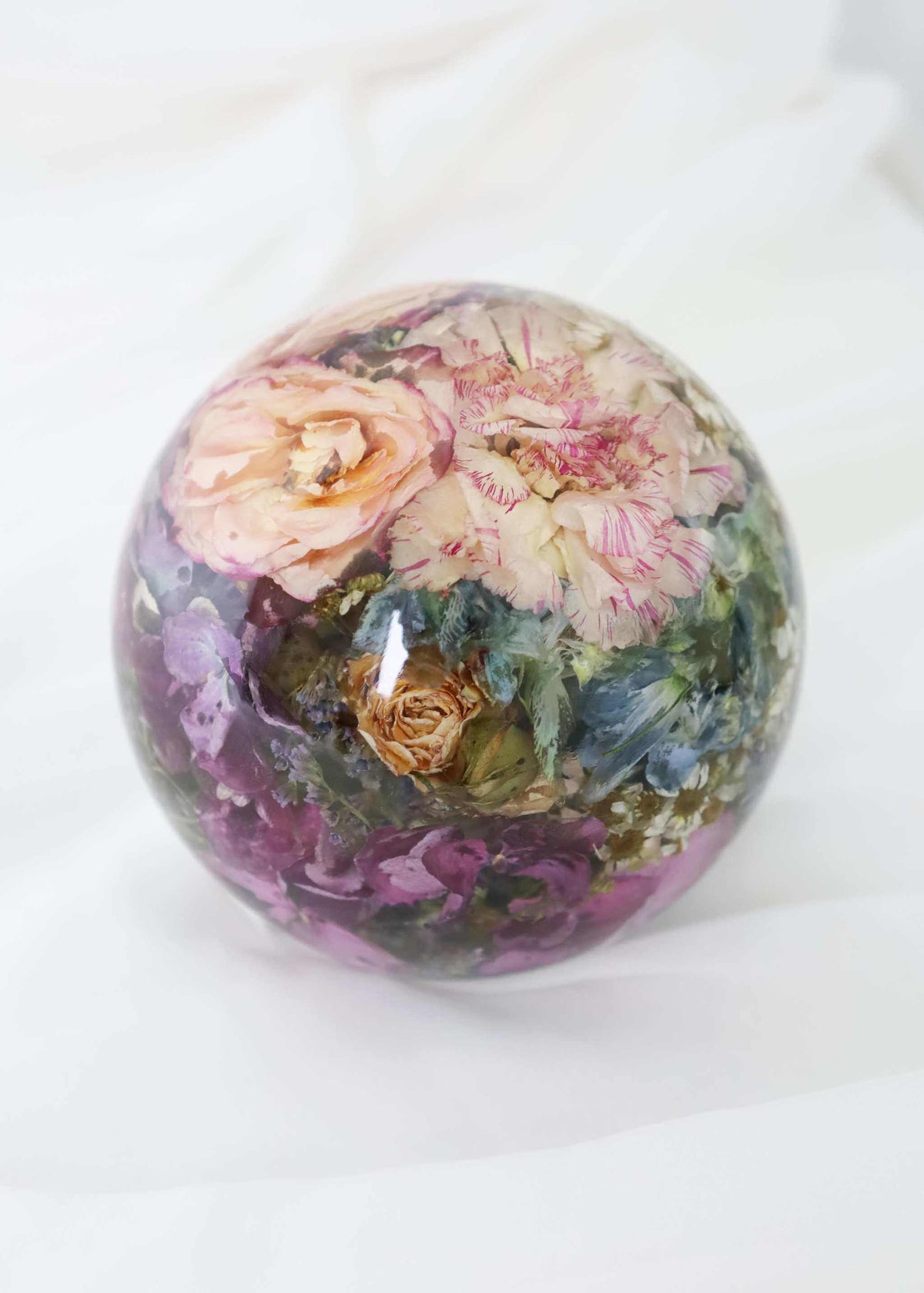 Resin dome paper weight preserving bridal bouquet flowers in clear sphere display