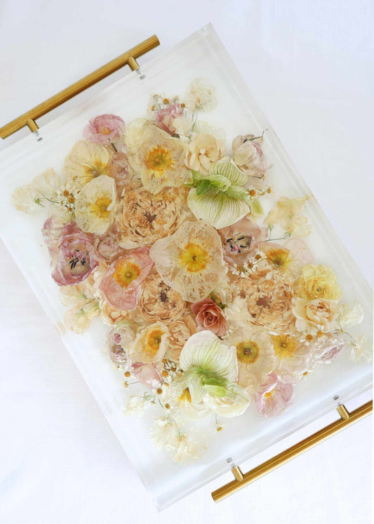 Resin Flower Serving Tray with clear resin encasing pastel pink, yellow, cream and green dried flowers and gold handles