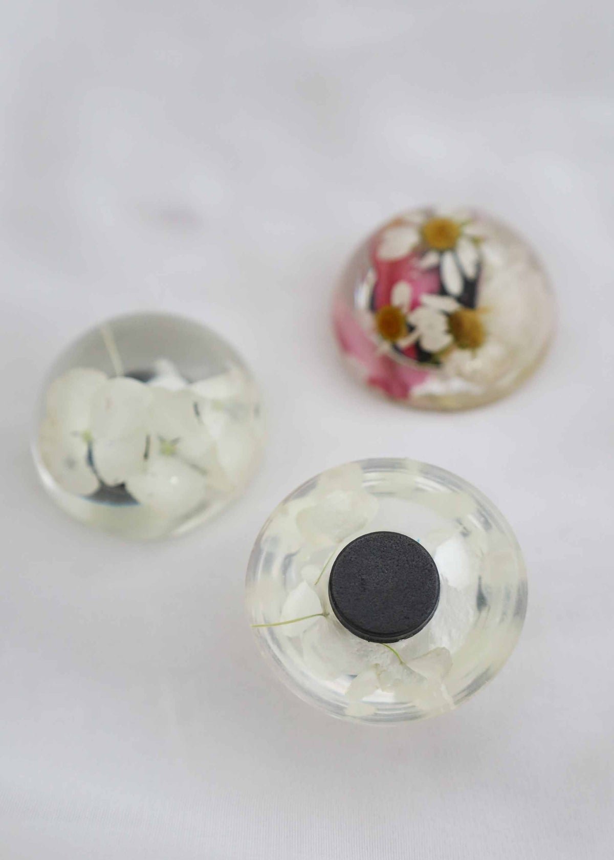 Set of small bridal bouquet flowers preserved in resin magnets for display